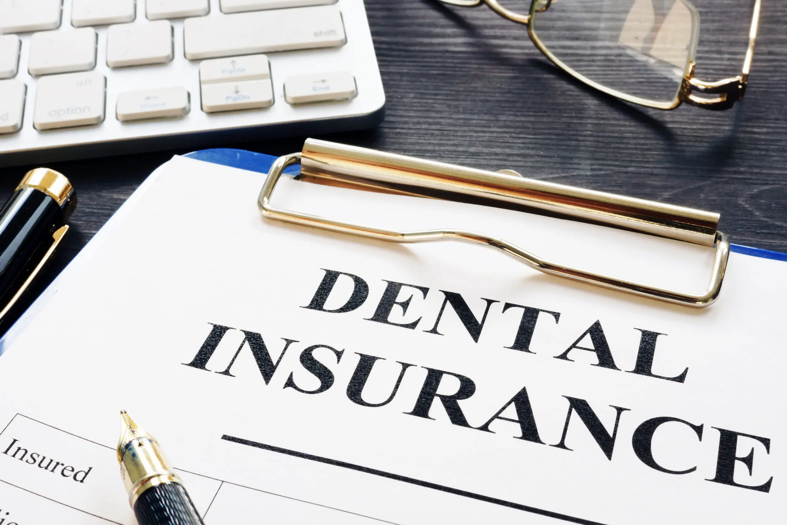 Dental insurance form with pen
