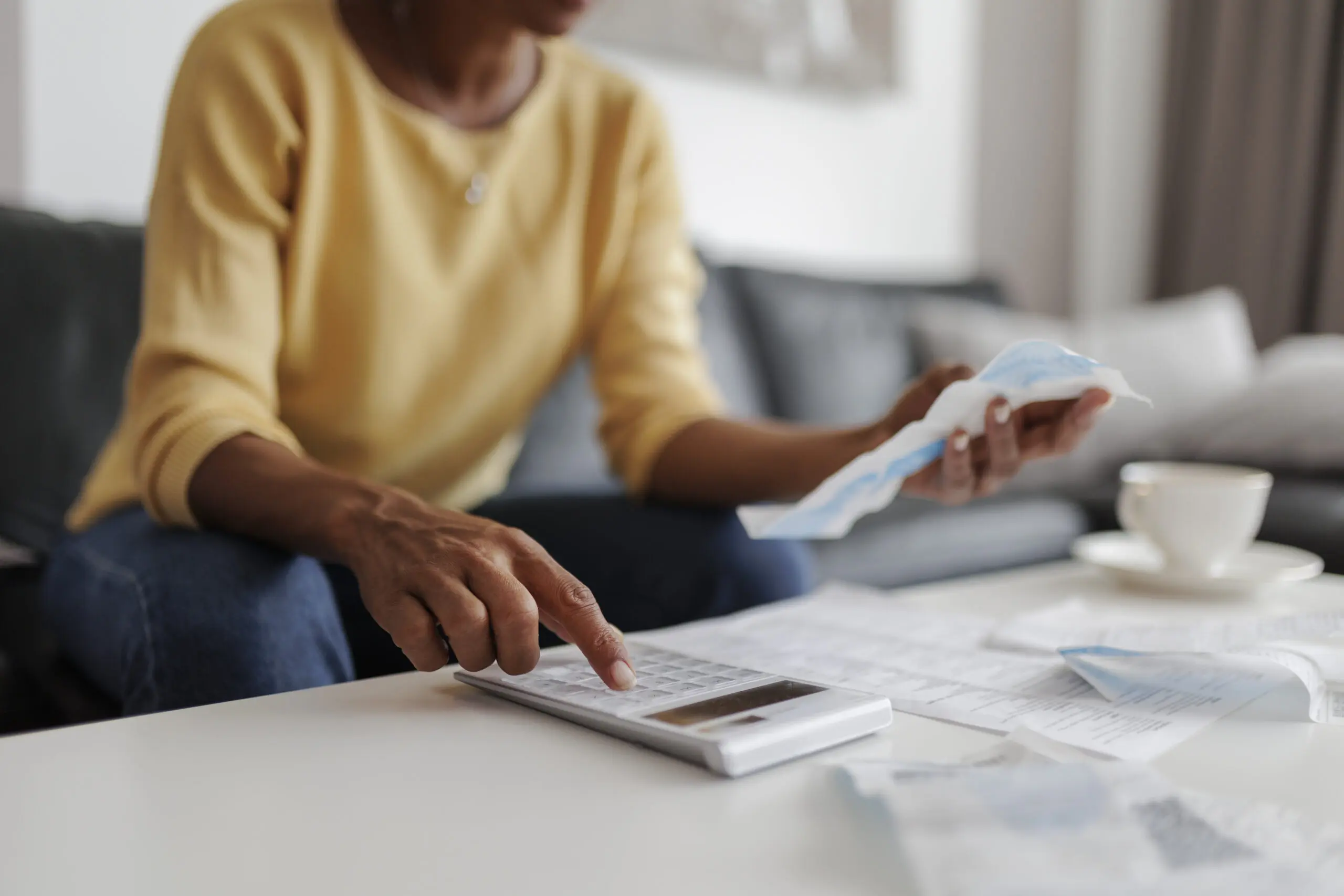 Budgeting with bills and calculator on table