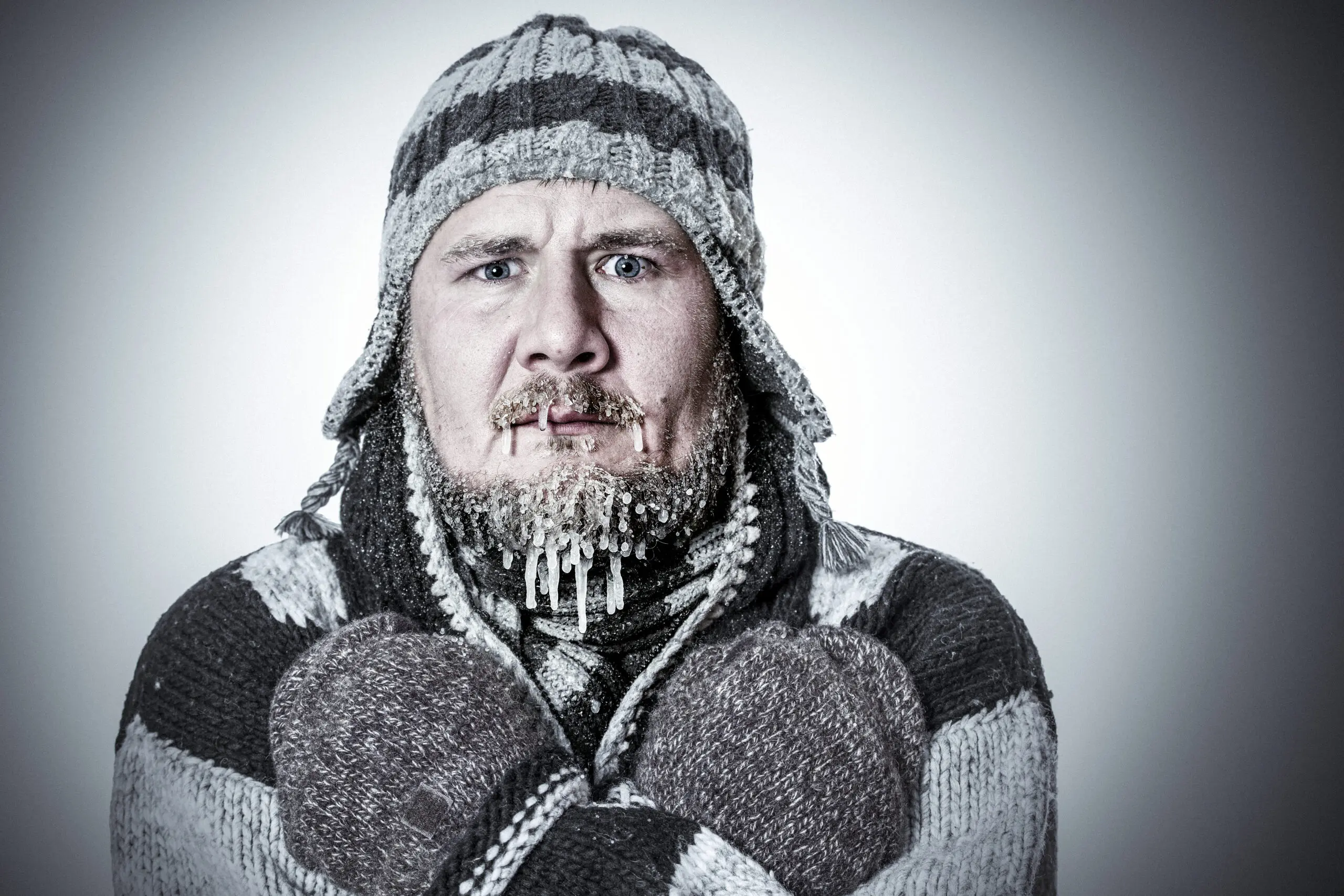 Man bundled in winter clothing, looking cold