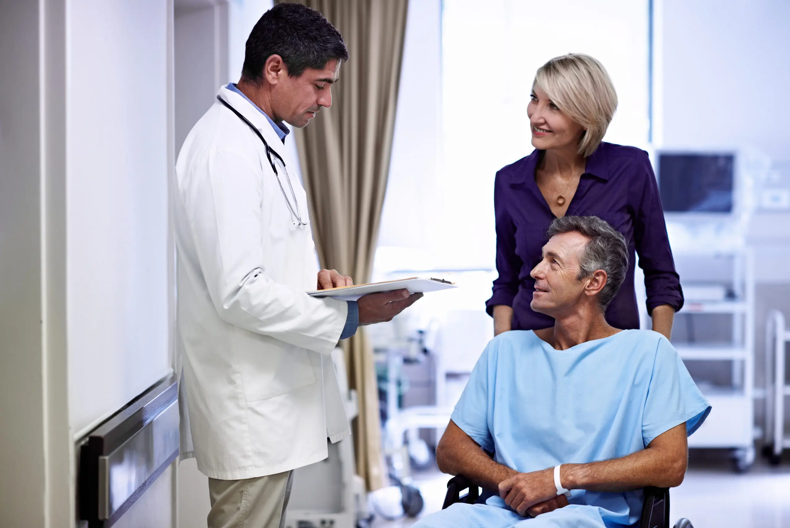Doctor consulting with patient in wheelchair