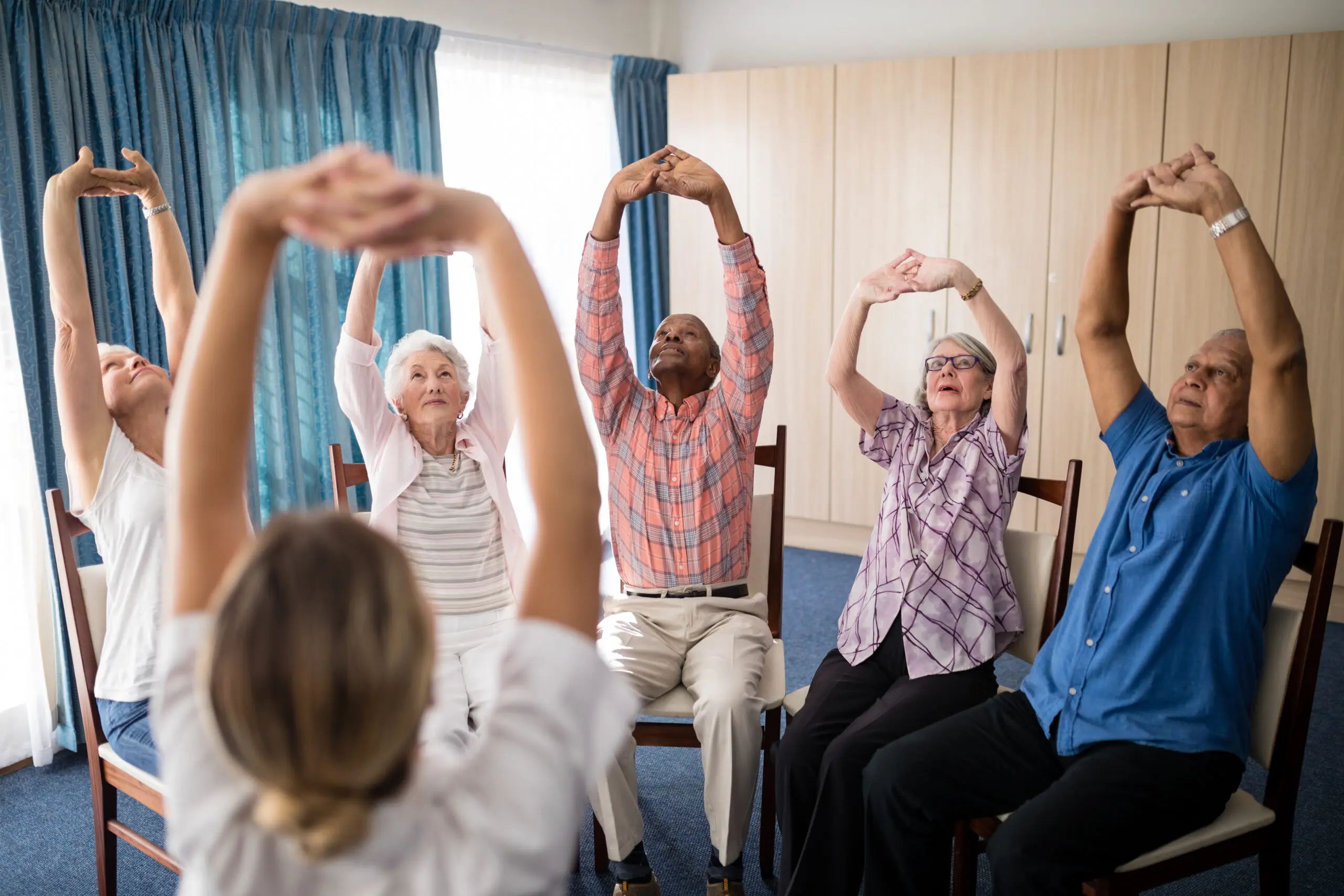 Elderly group doing seated exercises