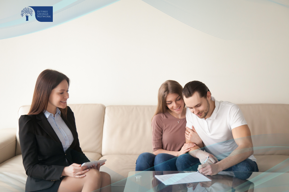 Couple signing document with advisor present