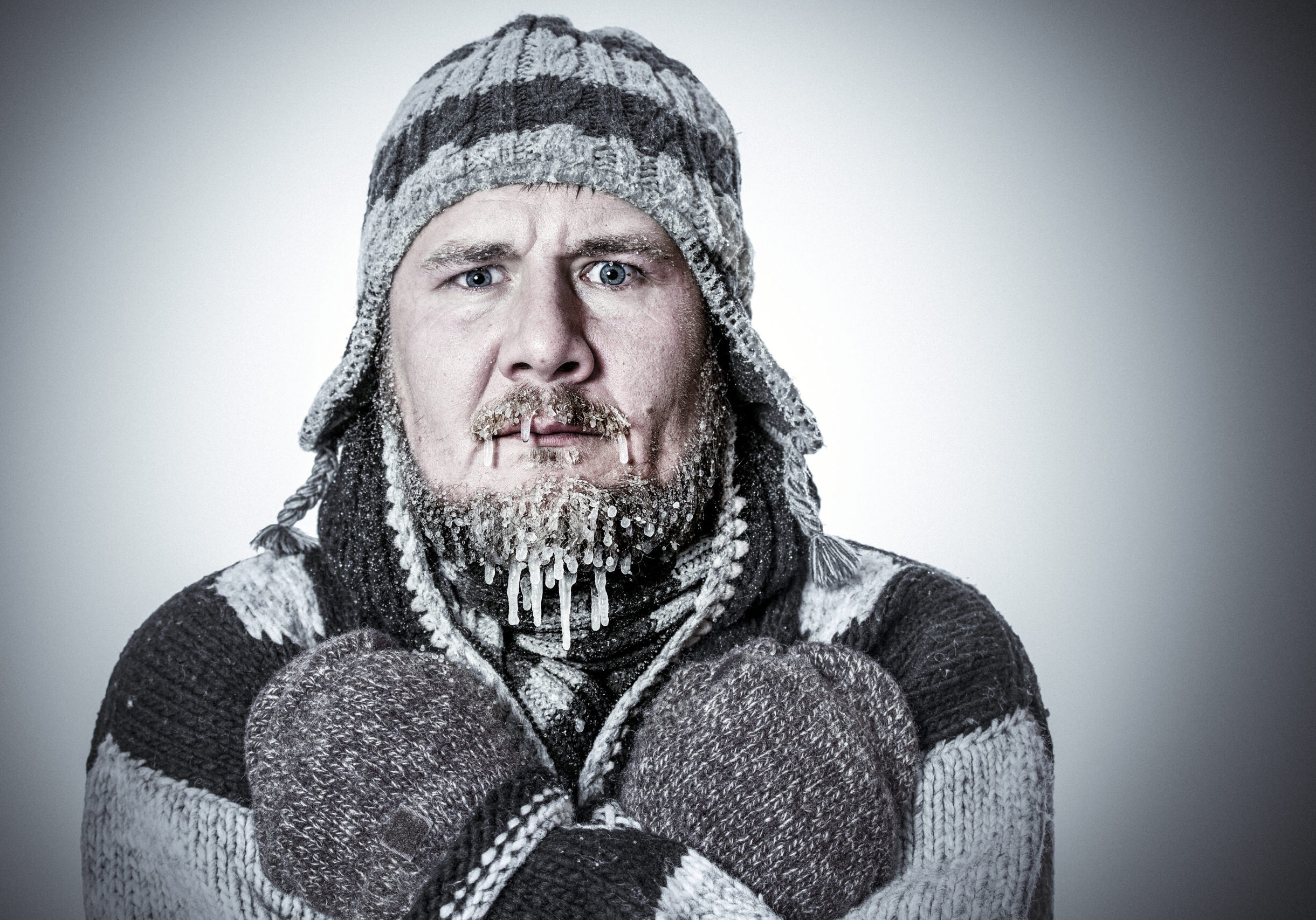 Man bundled in winter clothing, looking cold