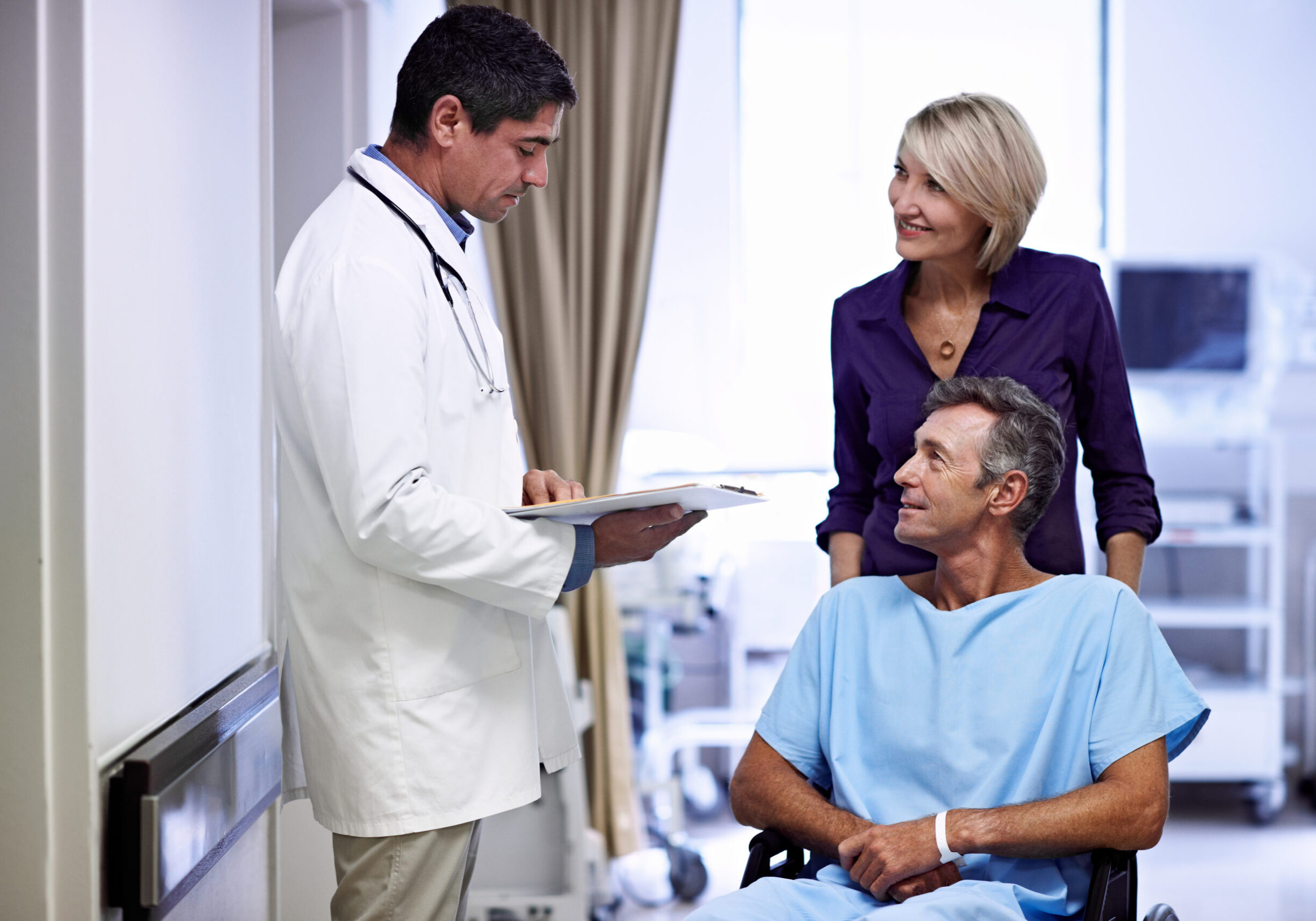 Doctor consulting with patient in wheelchair
