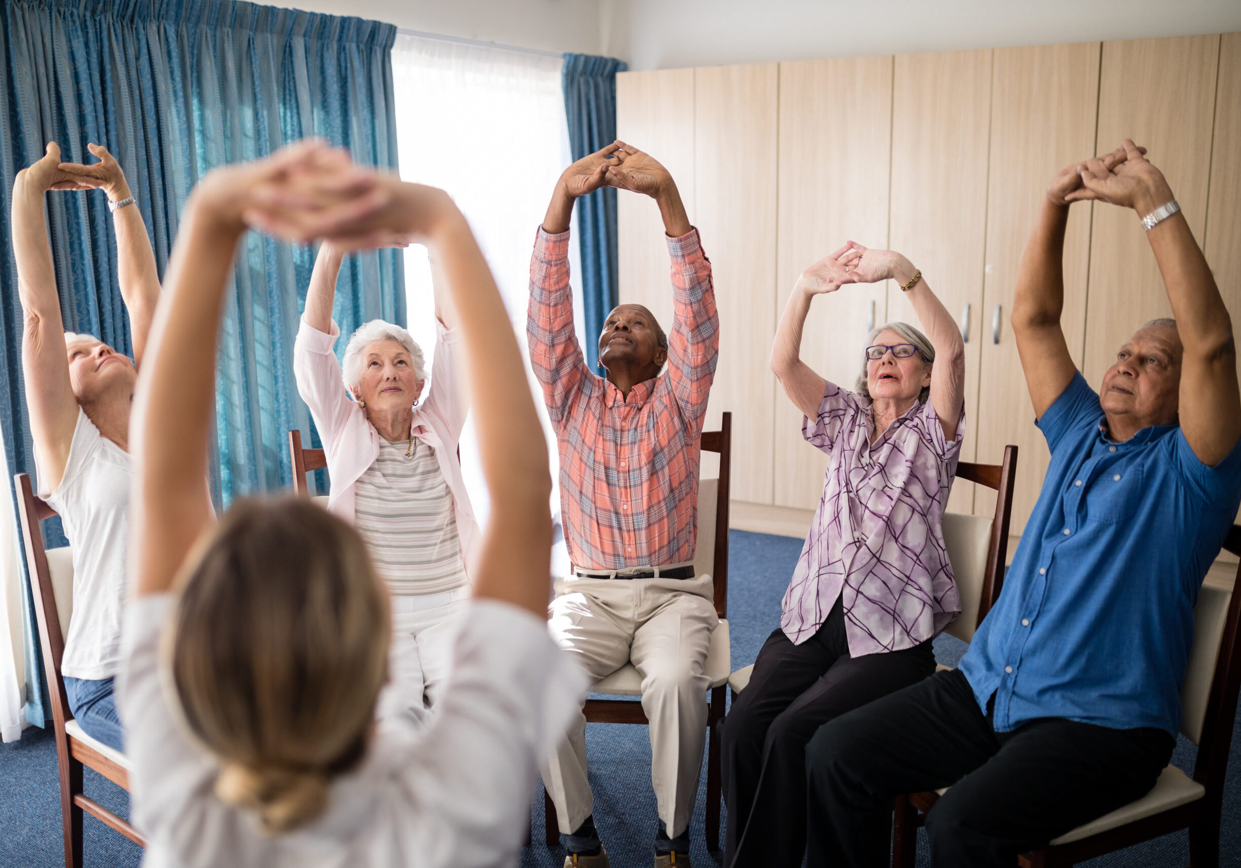 Elderly group doing seated exercises